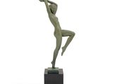 bronze statue of a woman holding a basketball ball on a marble base