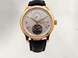 a gold wrist watch with a white dial and a black leather strap