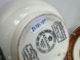 a close up of a vase and a plate on a table
