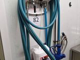a blue hose attached to a white wall with a blue hose attached to it