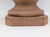 a statue of a man sitting on top of a pedestal