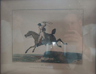 une photo encadrée représentant un homme à cheval, muni d'un lasso
