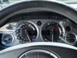a close up of a car dashboard with a steering wheel