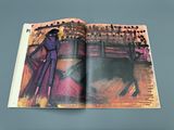 an open book with a picture of a bull and a woman in a purple dress