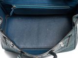the inside of a blue handbag with a zipper on the inside