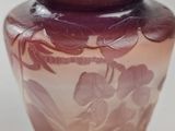 a purple vase with a floral design on it