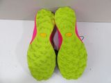pair of neon green and pink running shoes on a white surface