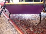 a purple chair that is sitting on a rug on the floor