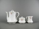 three pieces of porcelain tea set on a grey background