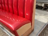 a red bench that is sitting on a clear table
