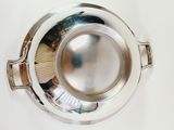 a silver plate with a wooden handle on a white table