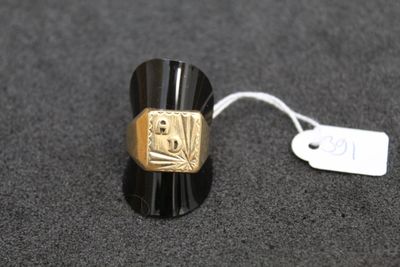 a black and gold ring with a tag on it