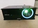 an image of a projector with a green light on it