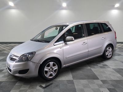 a picture of a silver minivan parked in a garage