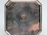 an antique silver plate with a gold ring on it