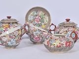 three different types of teapots and saucers on the table