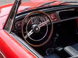 a red car with a wooden steering wheel and dashboard
