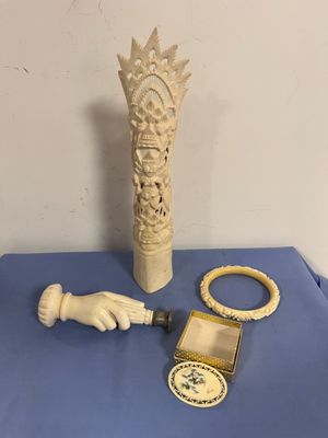 a picture of a table with a vase, bracelets, and a watch