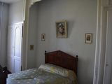 a bedroom with a bed and a picture on the wall