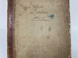 an old book sitting on top of a white table
