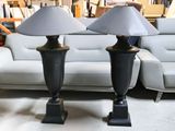 two lamps that are sitting on a table in a room