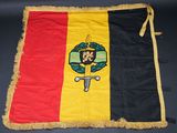 a close up of a flag with a man holding a sword