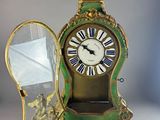 a clock that is sitting on a table next to a mirror