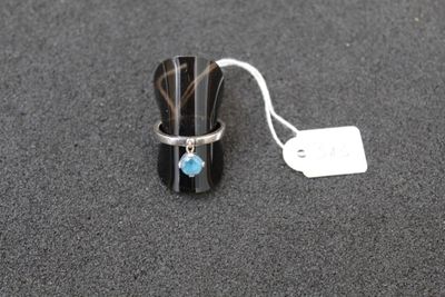 a ring with a blue stone on it sitting on a table