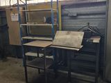 a room with a desk and shelves in it