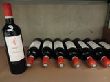 bottles of wine are lined up on a counter top