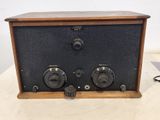 an old fashioned radio sitting on a table