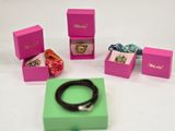 a box that has a bracelet, a bracelet, and a ring in it