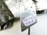 a piece of metal with a tag on it