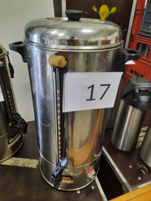 a coffee urn on a table with a price tag on it
