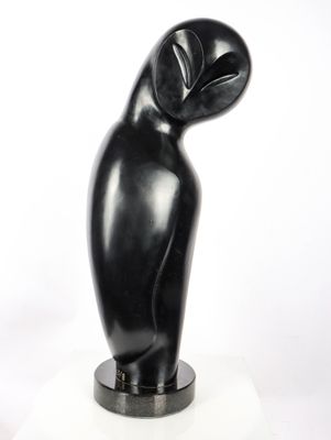 sculpture of a black bird on a white pedestal