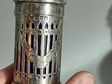 someone is holding a small silver object in their hand