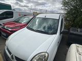 cars parked in a lot with a cloudy sky in the background