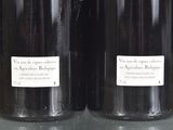 two bottles of wine that are sitting on a table
