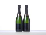 two bottles of champagne sitting on top of a table