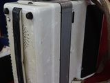 a white accordion sitting next to a suitcase on a table
