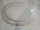 a white plate on a table with a white table cloth