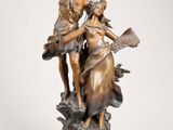 an image of a bronze statue of a woman playing a harp