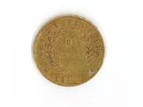 an image of a gold coin sitting on top of a white surface