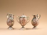 three different sized vases sitting on top of a table next to each other
