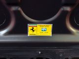 a sticker on the bumper of a car with a ferrari logo on it