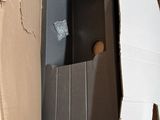 a box that has a toilet in it in the middle of it