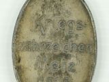 an old silver medal with the name of a man on it