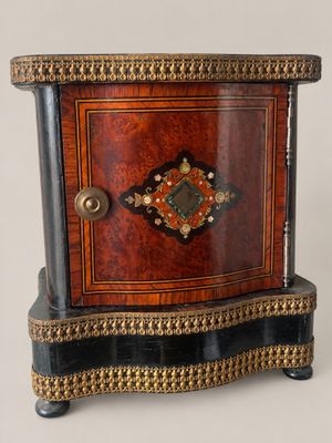 a small wooden box with a decorative decoration on it