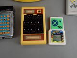 several electronic toys on a table next to a banana