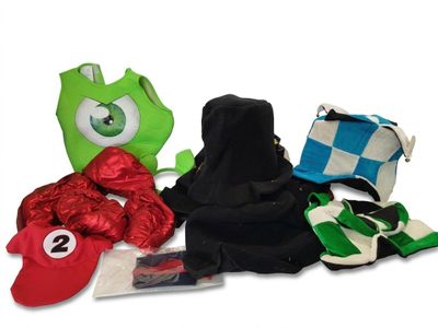 a pile of items that include a backpack, a hat, a scarf, and other items
